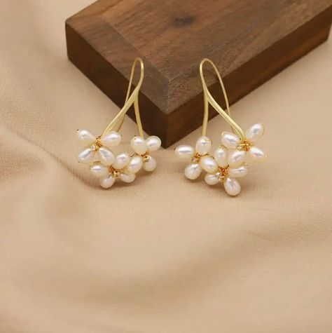 These floral pearl drop earrings are handmade with multiple real AAA quality freshwater pearls and are simply beautiful. The pearls have a smooth, natural white surface that is glowing, and the pearls are designed with a flower-like pattern that encases the pearl and adds a charming touch of beauty. The earrings are delicate, and the white pearls and floral design perfectly complement each other to form an exquisite piece of jewelry. The perfect statement piece for a bride or make them your go-t Bride Earrings Pearl, Pearl Ball Earrings, Wedding Pearl Earrings, Unique Pearl Earrings, Flower Pearl Earrings, Handmade Earings, Modern Pearl Jewelry, Pearl Earrings Handmade, Earrings Multiple