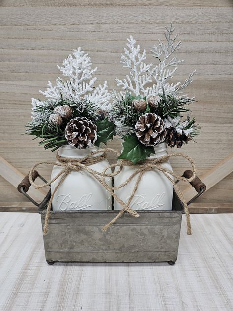 This farmhouse Christmas centerpiece is the perfect addition to your Christmas decor. This set includes 2 quart size Ball mason jars with jute bows, each hand painted in a winter white chalk paint and filled with a Christmas arrangement. Perfectly suited for a kitchen counter, table or mantle centerpiece! Makes a great gift too! The jars are nicely arranged in a galvanized metal tray with handles.  Set Arrangement (as pictured): (2) quart jars hand painted winter white (2) Christmas arrangements (2) jute bows (1) galvanized metal tray Jars are not dishwasher safe, and can not be submerged in water. They are easily cleaned using a damp cloth only.  Delivery is made by USPS. Tracking number provided.  Please do not hesitate to contact me if you have any questions.  Thank you for visiting my White Christmas Farmhouse Decor, Winter Season Decor, Winter Themed Centerpieces Diy, Winter Round Table Decor, Farmhouse Winter Wedding, Winter Table Centerpieces Wedding, Winter Themed Baby Shower Centerpieces, Winter Baby Shower Table Centerpieces, Winter Console Table Decor