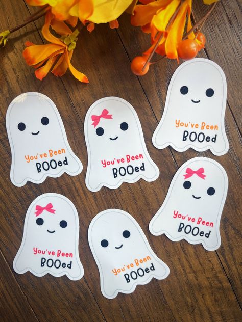 You will receive 12 personalized BOO Gram Tags Start your neighborhood or friends booing tradition with these simple ghost tags. How to "boo". Your neighbors? Get some Halloween treats together and leave your surprise on the porch, with the adorable " You've Been BOOed" tag.   Please use the drop-down box to choose what style sticker you would like to receive and if you would like a name added. You can also choose to have your tags hole punched if you prefer to hang them and not stick them onto something. ★☆Your stickers will arrive in the mail, ready to stick on your friends treats!  ★☆What makes our shop different? - Made with high-quality sticker vinyl, laminated to add another layer of protection. - Easy To Peel -Scratch Resistant - Tear Resistant - Waterproof We believe in a high-qual Boo Gifts For Coworkers, Boo Gram, Boo Grams, Boo Your Neighbors, Simple Ghost, Been Booed, Spooky Basket, Boo Gift, You've Been Booed