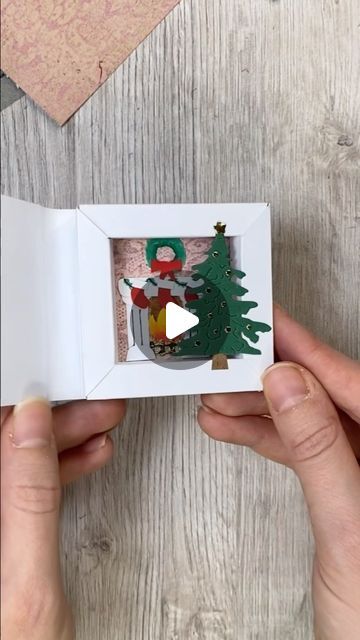 Katharina Tarta on Instagram: "Another shadow box idea, this time with a Christmas theme 😊 And the best thing: You can built up any scene you want in there 😊 A snowy landscape, a pile of gifts, carol singer? What ever you like and gets you in a Christmas mood 😉 Anyway, hope you like this little paper Christmas idea 😊 Ad: The beautiful design paper is from @raindroplila The one I used here just reminded me of a tapestry in a super cosy family home at Christmas, so I just had to use it this way 😊 #christmascrafts #christmascard #papercrafts" Christmas Shadow Box Ideas, Cosy Family Home, Shadow Box Christmas, Christmas Shadow Boxes, Christmas Craft Fair, Matchbox Art, Christmas Idea, Snowy Landscape, Design Paper