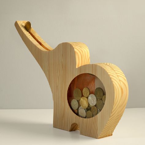 Discover a fun and charming way to save money with our Handcrafted Elephant Coin Bank. This whimsical coin bank is a unique blend of artistry and practicality, designed to make saving money an enjoyable experience.

Each coin bank is meticulously handcrafted from wood, showcasing the dedication of skilled artisans. Piggy Banks, Coin Bank, Unique Animals, Scroll Saw, Pet Bowls, Money Saving, Animal Design, Handmade Wooden, Meal Time