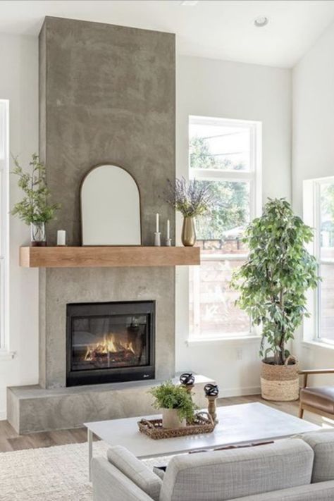 Looking for warmth without the clutter? Our blog post highlights chic electric fireplaces that fit perfectly into small spaces. They're not just practical—they're a style statement. Click to discover which model has the cozy factor you're after. Your snug retreat is just a read away. #GoTinySpace #ElectricFireplaces #CozyHome #InteriorDesign Living Room With Concrete Fireplace, Earthy Fireplace Decor, Cement And Wood Fireplace, Neutral Fireplace Ideas, Concrete Fireplace With Wood Mantle, Sheetrock Fireplace, Concrete Look Fireplace, Interior Fireplace Ideas, Fireplace No Chimney