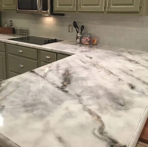 Marble is a gorgeous stone that exudes classical elegance, but it can cost a fortune. Marbleizing is a skillful technique you can use to create a faux marble finish that takes any piece to the next level. You can do marbleize a variety of surfaces, like ceramic tile, Formica countertops, kitchen cabinets, backsplash wood, linoleum, and more. To get a classic, chic, faux-Carrara marble effect in your own home or for your furniture refinishing project, follow this week’s Finish Friday video. In Faux Marble Countertop, Replacing Kitchen Countertops, Interior Design Blogs, Kitchen Remodel Countertops, Diy Kitchen Countertops, Formica Countertops, Kitchen Countertop Materials, Painting Countertops, Epoxy Countertop