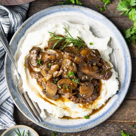 Transform an affordable cut of meat into tender, juicy beef that's topped with a rich and savory mushroom and onion gravy. Cooked low and slow, this smothered round steak is an easy, comforting dinner to enjoy over a plate of mashed potatoes or egg noodles! Smothered Round Steak, Steak And Cheese Sub, Beef Round Steak, Round Steak Recipes, Dry Soup Mix, Comforting Dinner, Comfort Dinner, Beef Round, Easy Steak Recipes