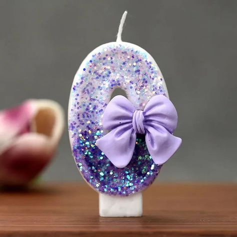 Material: Paraffin Make any celebration extra special with these dazzling number candles! Covered in shimmering purple glitter and adorned with delicate lavender bows, these candles bring a touch of elegance and charm to birthdays, anniversaries, and milestone events. Perfect for adding a glamorous and coquette-inspired aesthetic to your cake, these candles are a must-have for stylish celebrations. Number Candle, Design Cake, 3d Design, Birthday Candles, Cake Topper, Cake Toppers, Candles, Cake, Birthday