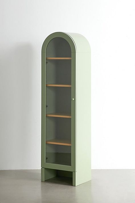 An elegant way to display your fave trinkets, this arc-shaped curio cabinet is crafted from bentwood, MDF & birch. Complete with 5 adjustable shelves and a door that creates a bohemian-style gallery vibe. Two people recommended for handling. Available exclusively at Urban Outfitters. Features Arc-shaped curio cabinet from our Mason furniture collection 5 adjustable shelves Content + Care Bent wood top, MDF, birch veneer, solid birch Wipe clean Imported Size Dimensions: 18" l x 13.75" w x 66" h Shelf 1 dimensions: 16.5" l x 11.5" w x 10.47" h Shelf 2-5 dimensions: 16.5" l x 11.5" w x 11.25" h Leg height/Clearance: 5.86" Weight: 99.2 lbs Shipping package dimensions: 21.25" l x 16.9" w x 70.5" h Shipping package weight: 109.1 lbs | Mason Curio Cabinet in Dark Green at Urban Outfitters Wall Cabinet Bedroom, Cd Storage Ideas, Green Shelves, Display Books, Birch Veneer, Pinterest Contest, Uo Home, Glass Panel Door, Bent Wood