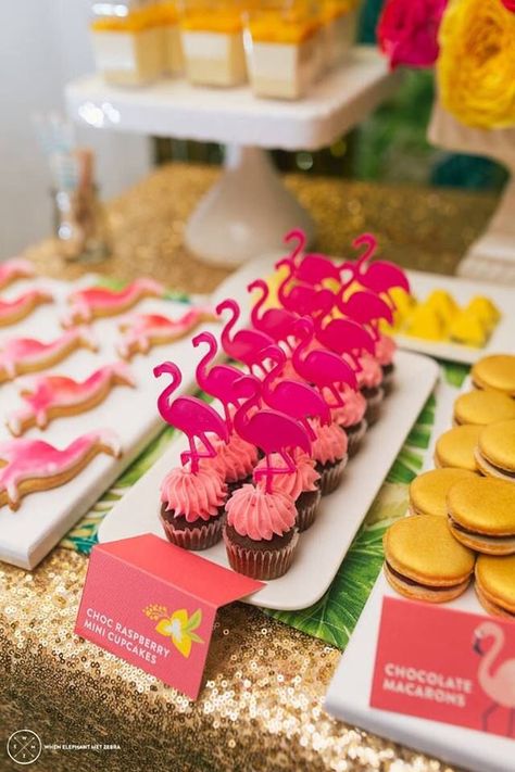 Dress up your tropical dessert display with chocolate raspberry cupcakes topped with flamingos! The gold sequin table cloth makes this area a statement piece! Hawaiian Cupcakes, Flamingo Cookies, Flamingo Cupcakes, Pink Flamingo Party, Flamingo Themed Party, Tropical Birthday Party, Flamingo Pool, Aloha Party, Flamingo Birthday Party