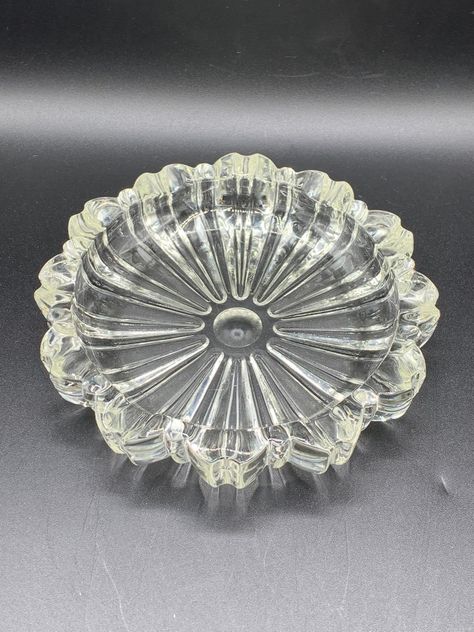 Made by Fostoria Glass Co. Circa 1938-1944. Spool Pattern #2550. This ashtray was the largest of three ashtrays that Fostoria sold as a set in blue, gold tint and clear colors. Thick, seamless glass. Large clear ashtray measures 5 5/8″ wide with four rests. Condition: Used / Excellent / No visible imperfections. I'm crazy about rescuing vintage housewares! I love to locate and then pass on these treasures to someone who will love and value them. I hope that's you 😊 *All of my vintage items are Antique Ashtrays Vintage, Vintage Glass Ashtrays, Fostoria Glassware, Crystal Glassware Antiques, Vintage Dishes Antiques, Antiques Value, Vintage Glassware Antiques, Fostoria American, Fostoria Glass