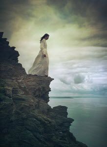 Mark Owen WOMAN STANDING ON CLIFF EDGE BY SEA Falling Off A Cliff, Standing On A Cliff, Someone Falling, Edge Of A Cliff, Cliff Edge, Mark Owen, The Encounter, A Level Art, Woman Standing