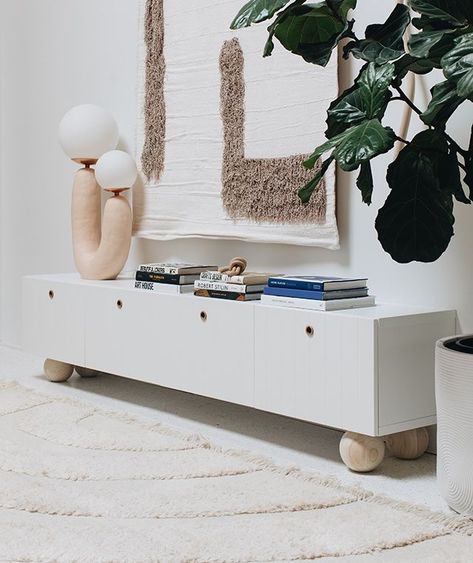 If you notice, you can't actually see the TV, and the way she has hidden it is a bit of a top decor tip in its own right. 'The TV is hung just above the cabinet so it is at eye level when you are siting down,' Sarah says. 'The tapestry that hangs over the TV measures 4′ x 6′. It works great to cover the TV when it is not in use, but I hung it there more for scale than anything. The TV is much too small to carry the height of this wall and by using the super tall tapestry above the low media ... Sarah Sherman Samuel Living Room, Ikea Media Cabinet, Ikea Bestå Hack, Besta Hack, Wood Hardware, Media Units, Diy Cabinet, Ideas Habitaciones, Cabinet Diy