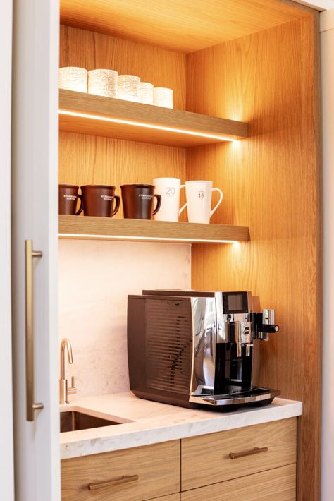 Adding cabinetry lighting into the design of your appliance cabinet adds both beauty and function. It adds a soft low light which is especially handy when you're getting your first coffee.  This appliance cabinet also features a small sink which adds so much to the functionality of the space. Coffee Station Kitchen With Sink, Pantry With Small Sink, Small Coffee Bar With Sink, Coffee Corner With Sink, Small Pantry With Sink, Coffee Bar Ideas With Sink, Coffee Station With Sink, Coffee Nook Cabinet, Corner Coffee Nook