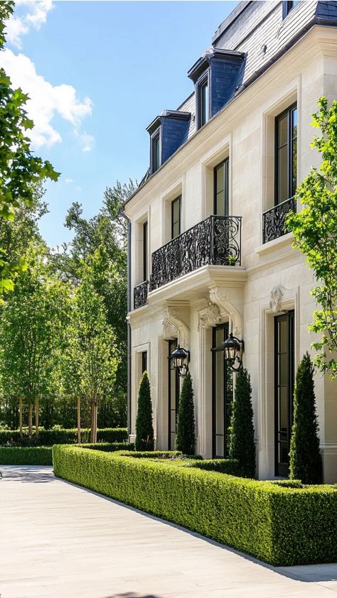 Elegant estate with manicured hedges, decorative wrought iron balconies, and large windows, surrounded by lush greenery. City House Exterior, Modern French House Design, Modern French Architecture, French House Exterior, French Architecture Homes, Modern French House, French House Design, House Exterior Architecture, City Houses