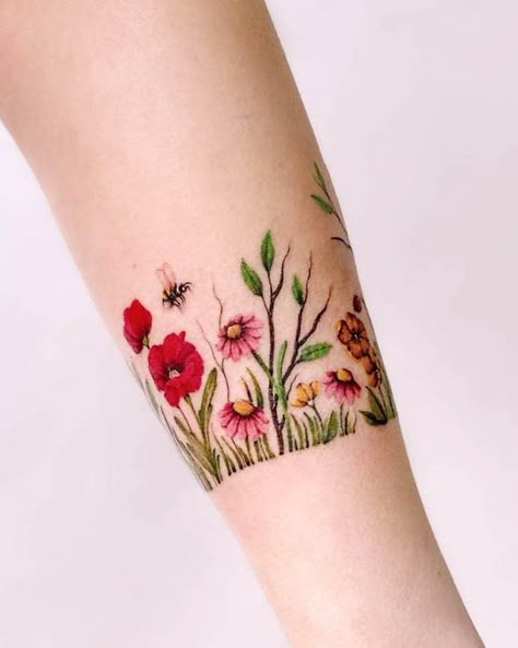 Flower garden bracelet tattoo by @maiko.only Around The Arm Flower Tattoo, Tattoo Flower Bracelet Wrist, Wildflower Cuff Tattoo, Birth Flower Arm Band Tattoo, Wildflower Arm Band Tattoo, Garden Lover Tattoo, Flower Garden Tattoo Ideas, Wildflower Band Tattoo, Womens Wrist Tattoos Ideas Beautiful