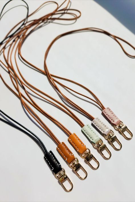 Introducing our sleek leather neck lanyard, and say goodbye to fumbling through pockets or bags to find your ID or keys. ✨ With our ID badges holder, you can keep your hands free and your essential items securely in place, plus the round leather cord is comfortably worn around neck. #leatherlanyard #lanyardnecklace #leather Leather Working Patterns, Leather Wallet Pattern, Neck Lanyard, Leather Lanyard, Leather Craft Projects, Lanyard Necklace, Sunglasses Strap, Leather Keyring, Wallet Pattern