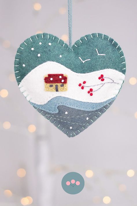 Felt heart Christmas ornament with an Irish cottage in a snowy landscape. #feltchristmasornaments #irishornaments #irishlandscape #irishcottage Diy Felt Christmas Ornaments, Handmade Felt Ornament, Felted Christmas, Colourful Christmas, Felt Ornaments Patterns, Heart Christmas Ornaments, Christmas Heart, Felt Crafts Christmas, Irish Cottage