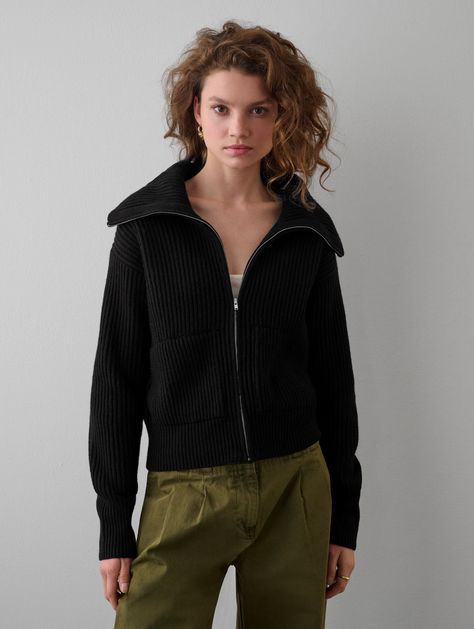 Ethically produced and responsibly sourced, our new Merino Blend Ribbed Zip Up Jacket offers a great new weight and texture to our transitional knitwear collection. With a cropped silhouette, our Zip-Up Jacket feels very much like a bomber style, with side pockets and a neckline that can be zipped up like a turtleneck or left open with a ribbed collar shape. Details Straight fit. Long sleeve. Length in size small is 21". The model is 5'11" and is wearing a size small. 55 % RWS Superfine Merino, Black Ribbed Sweater, Light Taupe Color, Terry Richardson, Boxy Sweater, Zip Collar, Sweater Oversize, Zip Cardigan, Collar Cardigan, Womens Cashmere