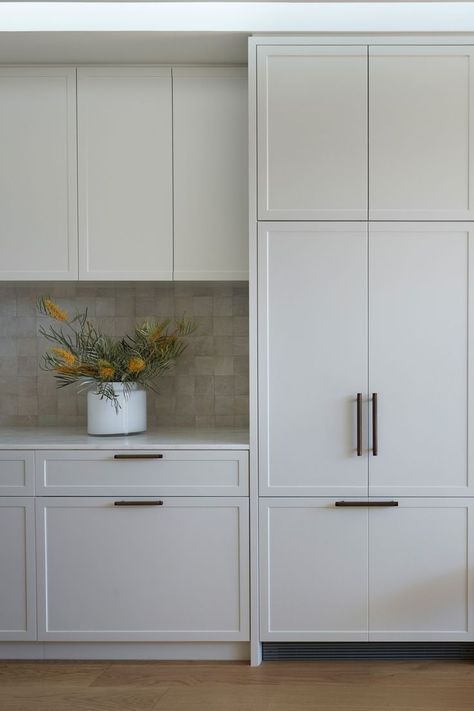 pale grey shaker kitchen joinery with brass handles, oak floors and white zellige tile splash back White Shaker Modern Kitchen, Clean White Kitchen Design, Shaker Island Kitchen, Slimline Shaker Kitchen, Narrow Shaker Kitchen, Neutral Shaker Kitchen, White Kitchens 2024, Slim Shaker Cabinets Kitchen, White Pantry Door