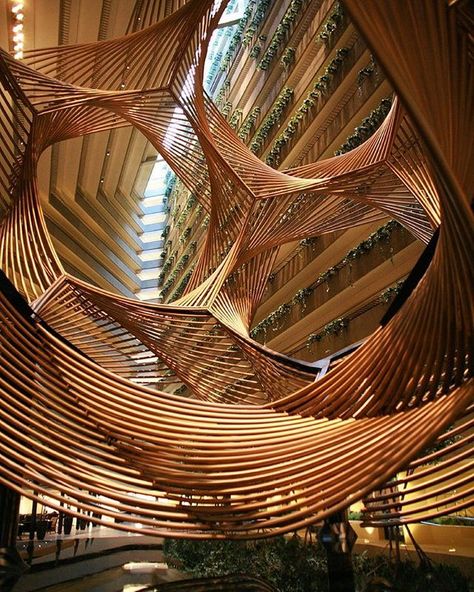 a monumental sculpture by american artist charles o. perry is suspended inside the hyatt regency in san francisco. 'eclipse' is a mathematically inspired, undulating, anodized aluminum form that spirals through the hotel's central atrium. photo by bill holmes  see more #artinstallations on #designboom #charlesperry Parametric Architecture, Parametric Design, Organic Architecture, Unique Architecture, Futuristic Architecture, Beautiful Architecture, Amazing Architecture, Architecture Building, Building Design