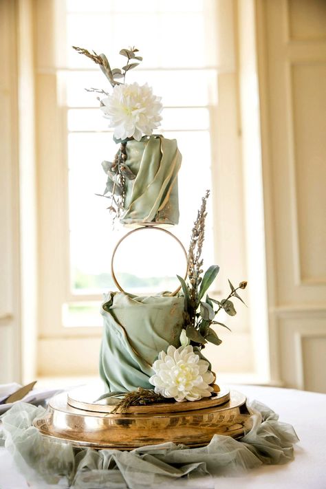 Elegance & beauty standing tall in beautiful shades of sage green featuring a hoop separator for elevation. 
Beautiful grounds at Stapleford Park, a refined country house hotel 
The perfect setting for intimate & luxorious weddings . Sage Green Theme Wedding Cake, Sage Green Cake Ideas, Wedding Cake Sage Green, Sage Wedding Cake, Sage Green Wedding Cake, Unique Cake Ideas, Sage Green Cake, Hexagon Wedding Cake, Bayou Wedding