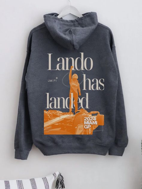 Celebrate Lando Norris's incredible P1 win at the Miami GP with the "Lando Has Landed" Hoodie. Perfect for any Formula One fan, this hoodie is all about showing your support for Lando and McLaren in style. Crafted for comfort and durability, it's ideal for race days, casual outings, or just relaxing at home. Made from ethically sourced US cotton and polyester, and dyed with eco-friendly colours, this hoodie is both stylish and sustainable. Whether you're a die-hard F1 fan or just love motorsport Lando Norris Hoodie, Formula One Merch, Lando Norris Merch, Mclaren Hoodie, Mclaren Outfit, F1 Clothing, F1 Hoodie, Miami Gp, F1 Merch