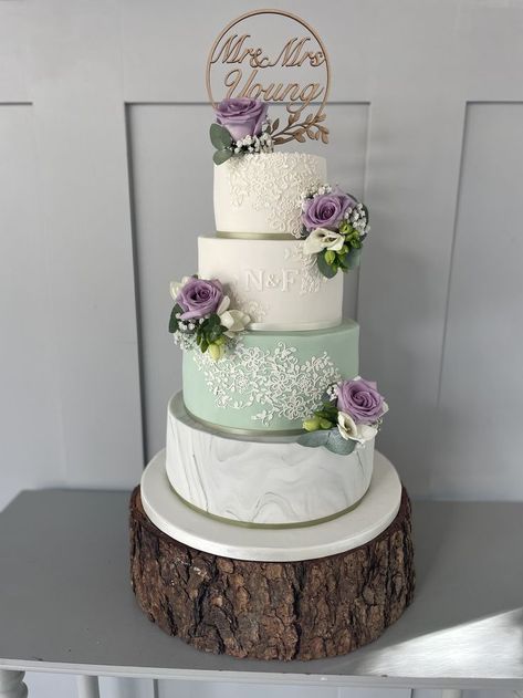 Faye, 4 tier wedding cake featuring a marble tier, edible lace and monogram incorporating the sage green and lilac colour theme with fresh flower clusters Sage Green And Lilac, Lavender Wedding Decorations, Wedding Cakes Lilac, Lavender Wedding Theme, Lavender Wedding Cake, Sage Green Wedding Colors, Green Wedding Decorations, Purple Wedding Cake, 4 Tier Wedding Cake