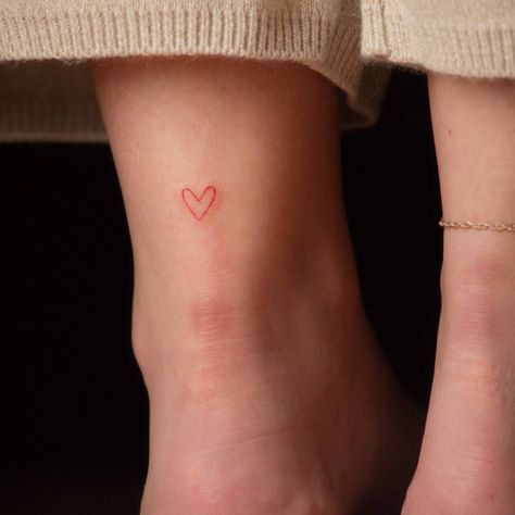 Minimalist red heart tattoo Red Ankle Tattoo, Heart Minimalist Tattoo, Back Of Ankle Tattoo, Red Heart Tattoo, Heart Tattoo Ankle, Dr Tattoo, Heart Tattoo On Finger, Love Heart Tattoo, Heart Minimalist