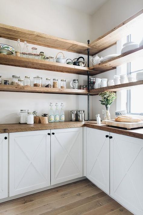 White kitchen cabinets accented with an x-trim and oil rubbed bronze knobs are finished with a rustic wood countertop. Beach Style Kitchen, Decor Ikea, Wood Kitchen Cabinets, Built In Cabinets, Wood Countertops, White Kitchen Cabinets, Open Shelves, Kitchen Makeover, Wood Kitchen