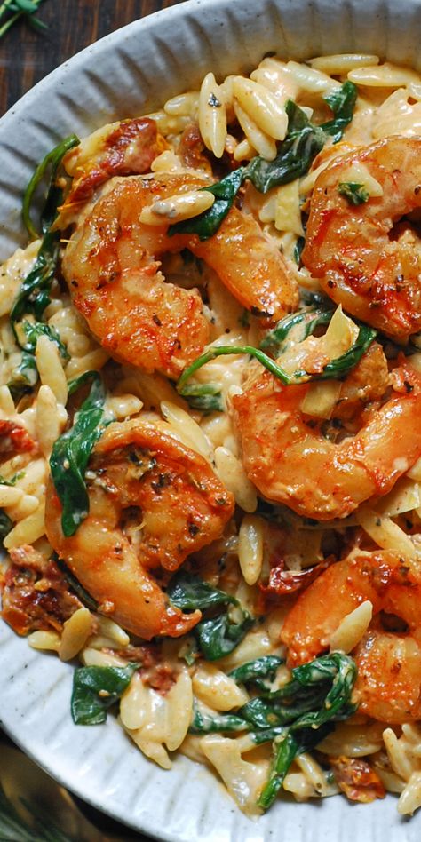 Creamy Tuscan Shrimp Orzo with Sun-Dried Tomatoes, Artichokes, and Spinach - in a white bowl. Shrimp Rositto, Creamy Tuscan Shrimp, Shrimp And Spinach, Shrimp Spinach, Tuscan Shrimp, Shrimp Orzo, Orzo Recipe, Seafood Dish Recipes, Creamy Shrimp