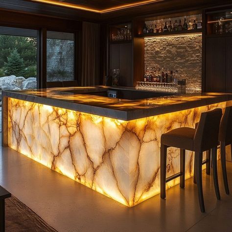 This stunning bar counter features backlit quartz, creating a warm, glowing ambiance that enhances any space with luxury and style. The quartz's natural veining, highlighted by soft lighting, makes it an eye-catching focal point in this modern home bar setup. Ideal for Pinterest users looking for material building ideas, quartz offers elegance and durability, making it perfect for unique, illuminated features in upscale interiors. Glowing Marble Counter, Illuminated Bar Counter, Light Up Countertop, Backlit Bar, Building Materials Architecture, Materials Architecture, Bar Casa, Home Bar Setup, Modern Home Bar