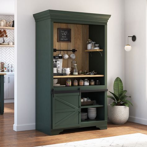 For a cozy and aesthetic touch to your interiors, bring our ergonomically designed Sherbrooke Solid Wood Barn Door Farmhouse Coffee Bar Hutch. With its charming design and ample storage space, it's a must-have for any coffee lover. Entirely handcrafted from solid wood, this beautiful coffee bar hutch boasts a 2-tone outlook that blends the charm of the rustic texture of solid wood with a hand-applied dark finish, resulting in a visually stunning design. In addition to its attractive look, the pi Bookshelf Turned Coffee Bar, Forest Green Coffee Bar, Green Coffee Bar Ideas, Armoire To Coffee Bar, Farmhouse Bar Cabinet, Vintage Stove Coffee Bar, Coffee Bar Colors, Dark Green Coffee Bar, Wardrobe Coffee Bar