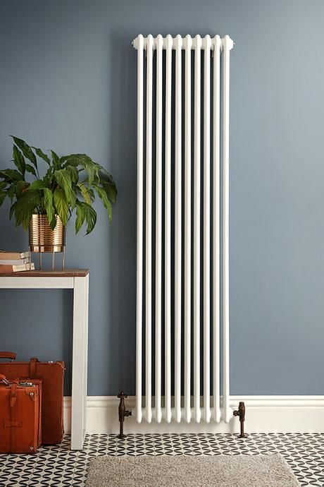 a tall white milano windsor radiator on a blue background #radiator #radiators #stylishradiators #interiors #interiordesign #decor #homedecor #interiorstyling Hallway Ideas White, Vertical Radiators Kitchen, Wall Radiators, Radiators Living Room, Lavabo D Angle, Tall Radiators, Kitchen Radiator, Best Radiators, Home Radiators