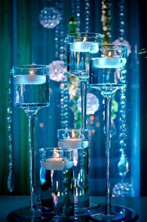 This pretty floating candle centerpiece provides a warm glow in shades of blue! Floating Centerpieces, Centerpieces Ideas, Sea Wedding, Blue Candles, Masquerade Party, Candle Centerpieces, Floating Candles, Glass Vases, Candle Lanterns