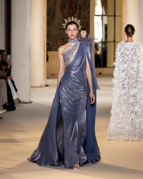 Granite blue mermaid dress in silk cloquet, with a game of draping on the skirt waving from the waist and hips. Flowy sleeves with collar attached blending into the overskirt. The movement is interrupted in the crystal and silver beading around the bodice. #TonyWardCouture #TonyWardHCFW2425 #PFW #CoutureWeek Blue Mermaid Dress, Tony Ward Couture, Fashion Show Dresses, Tony Ward, Fancy Dresses Long, Haute Couture Dresses, Formal Cocktail Dress, Fashion Figures, Fall Winter 2024