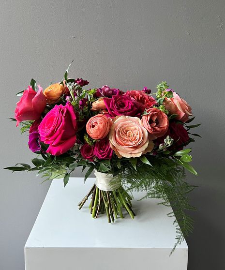 SKUs: WCBQTSM11, WCBQTMD11, WCBQTLG11 A gorgeous classically styled bouquet featuring a blend of red roses, coral spray roses, hot pink ranunculus, vibrant greenery, and other textures, hand-tied with a ribbon wrapped stem. Perfect for destination weddings, courthouse surprises, and romantic elopements.(No Vase Included) Garden Wedding Bouquet, Ribbon Wrap, Wedding Theme Colors, Spray Roses, Bridal Flowers, Rose Bouquet, Floral Centerpieces, Boutonniere, Bright Pink