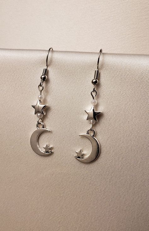 A set of earrings that feature moon and star charms along with small white pearls.  The hooks are made of nickel-free stainless steel. Earrings Aesthetic Silver, Moon Earring, Jewelry Accessories Ideas, Funky Jewelry, Drop Beads, Pearl Charms, Jewelry Inspo, Dream Jewelry, Stainless Steel Earrings