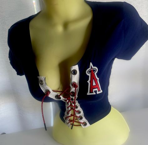 LA Angels Crop Top with red lace. Please note estimated time to ship these items is 7-10 business days as they are made to order. If you need it right away please send us a message and we will try our best to accommodate your request.  Don't see your team? Send us a message with a request and we will gladly accommodate it. What To Wear With A Pink Top, Shirts That Show Off Chest, Underboob Shirts Outfits, 2000s Crop Tops, 2000s Club Fashion, Unique Clothing Pieces, No Sew Top, Cute Red Tops, Bedazzled Clothes