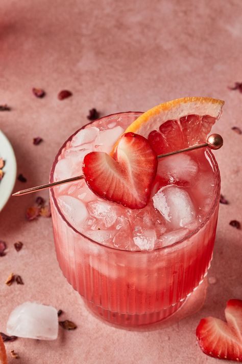 Raise you glass and get romantic with this refreshing love potion cocktail made with a mesmerizing blend of grapefruit juice, strawberry puree and sweet hibiscus syrup. Make this for your special someone this Valentine's Day, or share it with friends at your Galentine's celebration. Valentine Lotus Drinks, Valentines Cocktails, Prosecco Valentines Drink, Valentine’s Day Cocktail Recipes, Galentines Cocktails Tequila, Gin Valentines Cocktail, Hibiscus Cocktail, Hibiscus Syrup, Valentine Cocktails