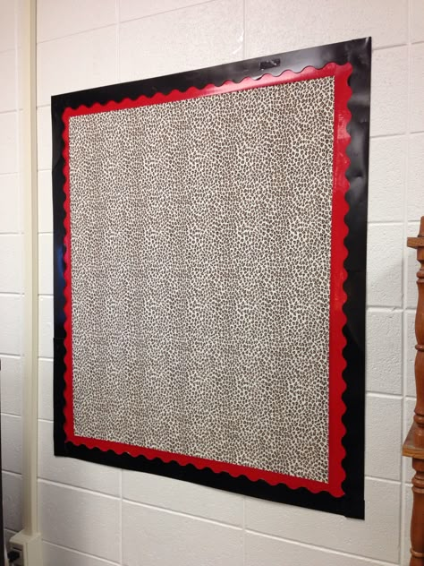 Created a brand new bulletin board on a bare wall with cheetah print fabric, taped to the wall with red duct tape border then layered with black paper border stuck to the duct tape with two sided permanent foam tape.  Super excited that I can put bulletin boards anywhere I want now!!! Red And Black Bulletin Board Ideas, Layering Bulletin Board Borders, Red Classroom Decor, Red Classroom, Preschool Classroom Themes, Math Bulletin Boards, File Decoration Ideas, Disney Themed Classroom, Bulletin Boards Classroom Decor