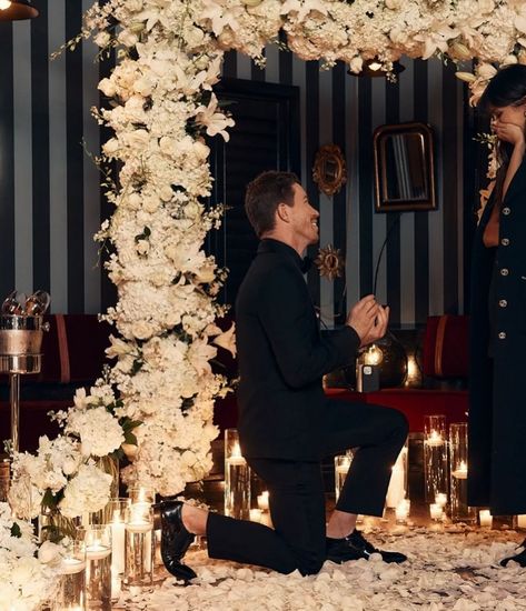 Imagine a dreamy indoor proposal in NYC. Picture him in Ralph Lauren, her stunning in Chanel, beneath an arch of white roses. With twinkling lights and elegant flowers, every moment is perfectly captured. Transform an ordinary week into an unforgettable celebration of love 🖤 Captured By: @andrewarthur Published By: @vogueweddings @voguemagazine Couple: @Nina & @shaunwhite Outfits: His: @ralphlauren | Hers: @chanelofficial Indoor Proposal, Nina Dobrev And Shaun White, City Proposal, Engagement Details, Shaun White, New York Times Magazine, Best Pajamas, Restaurant New York, Elegant Flowers