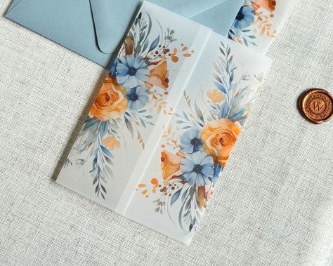 Use these pretty dusty blue and burnt orange watercolor flower vellum Jackets to accessorize your classy wedding invitations!  ------------- DETAILS: Light Weight (30#) or Heavy Weight (42#) Translucent Vellum Jackets Fit 5" x 7" Invitations Ship Flat, Scored or Folded ------------- SPECS ---30# wraps arrive flat, for you to fold them perfectly around your A7 Invitation ---42# wraps arrive scored or folded, for a generic fit Printed with archival, bold inks for a matte, semi-transparent look. Orange And Blue Wedding Invitations, Orange And Dusty Blue Wedding, Light Blue And Orange Wedding, Terracotta And Dusty Blue Wedding, Dusty Blue And Orange Wedding, July Wedding Invitations, Blue And Orange Wedding Theme, Ethereal Wedding Invitations, Wedding Invitation Vellum