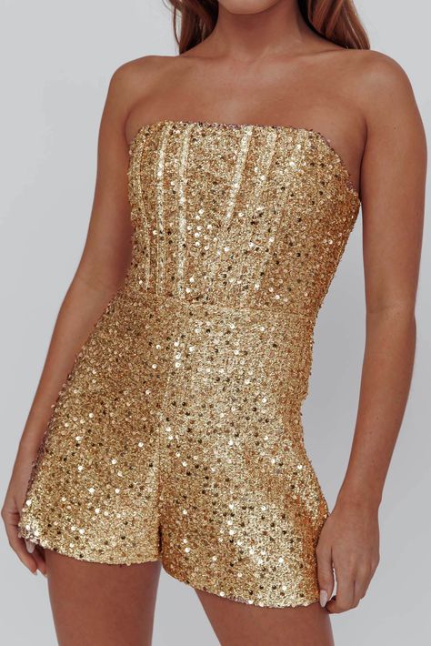 Gold, sequin romper Strapless style Lined Boning in bodice Zipper in back Get their attention in our gorgeous Vivid Dreams romper. We are obsessed with its sequin-embellished fabric and chic, structured bodice. Perfect for a big, birthday celebration. Team it with strappy, silver heels and a clutch for a look that's sure to turn heads. MODEL INFO Model is wearing size XS Height: 5'6" Bust: 32.0" Waist: 23.0" Hips: 34.0" CARE Hand Wash Cold. Do Not Iron. MATERIAL POLYESTER Golden Birthday Outfit, Gold Sequin Romper, Embellished Fabric, Shimmery Dress, Party Rompers, Sequin Rompers, Vivid Dreams, Golden Birthday, Fashion Statements