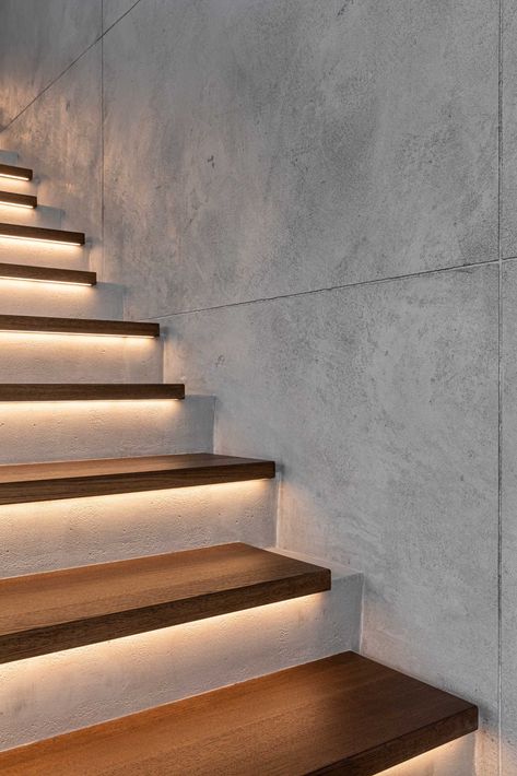 A modern home with concrete and wood stairs, that also include hidden lighting underneath the treads Stairs Lighting Ideas, Painted Stair Railings, Landing Decor, Stair Railing Makeover, Indoor Stairs, Stairs Lighting, Modern Stair Railing, Concrete Staircase, Contemporary Stairs