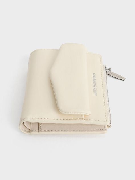 The Rachel is a classic top-zip wallet with a functional twist -- it features an envelope-flap front pocket that adds visual interest and extra storage space, keeping important small-item essentials even more readily accessible. With an elegant cream finish, the Rachel is wonderfully versatile and striking enough to be easily spotted in a crowded bag. The Rachel, Extra Storage Space, Pocket Top, Zip Wallet, Extra Storage, Card Case, Card Wallet, Front Pocket, Storage Space