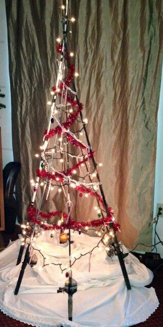 Fishing pole christmas tree.                                                                                                                                                                                 More                                                                                                                                                                                 More Fishing Rod Christmas Tree, Fishing Pole Decor Ideas, Fishing Christmas Tree Ideas, Fishing Themed Christmas Tree, Fishing Christmas Decorations, Fishing Pole Christmas Tree, Fishing Lure Christmas Ornaments, Fishing Christmas Tree, Fishing Ornaments