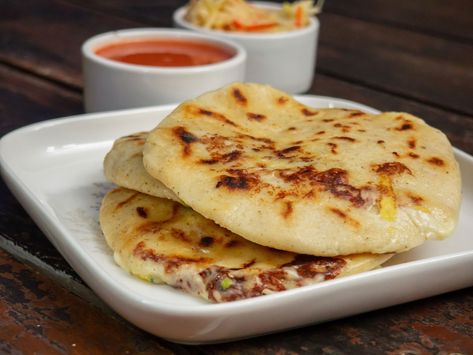 Pupusas, Must-Try Salvadoran National Dish El Salvador Recipes, Where To Travel In November, Salvadoran Food, Salvadorian Food, Small Cabbage, Latin American Food, Bean Enchiladas, National Dish, Small Tomatoes