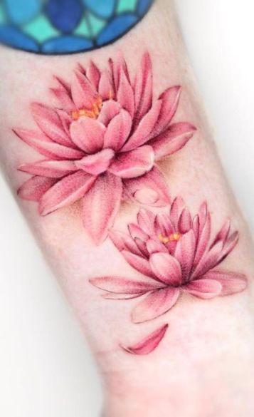 65 Spiritual Water Lily Tattoos, Meanings & Ideas - Tattoo Me Now Water Lily Flower Tattoo Designs, Water Lily Wrist Tattoo, Waterlily Tattoos For Women, Water Lilly Tattoo Color, Lotus Flower Tattoos For Women, Pisces Water Lily Tattoo, Water Lilly Tattoo Design, Water Lilly Tattoos, Colored Water Lily Tattoo