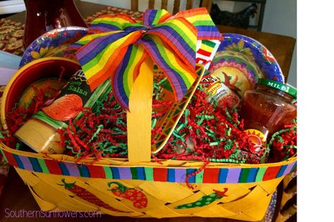 A great gift basket idea for Cinco de Mayo. Handpainted chili pepper gift basket filled with Cinco de Mayo gifts. #cincodemayogiftbasketideas #cincodemayogifts #themedgifts #giftideas #themedgiftbaskets #southernsunflowers Cinco De Mayo Basket Ideas, Mexican Themed Gift Basket Ideas, Diy Margarita Gift Basket, Fiesta Gift Basket Ideas, Cinco De Mayo Gift Basket Ideas, Mexican Themed Gift Basket, Gift Basket Ideas For Work, Taco Gift Basket Ideas, Mexican Gift Basket