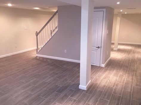 Staircase in the middle of the basement Basement Modern, Grey Wood Tile, Basement Layout, Shoji White, Basement Inspiration, Basement Family Room, Waterproofing Basement, Basement Stairs, Small Basements