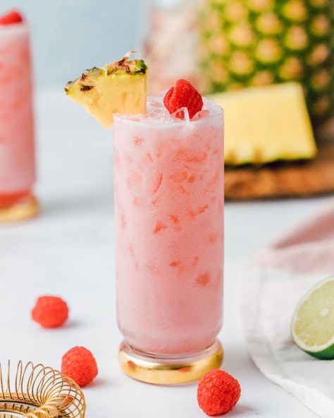 Learn how to make this Creamy Tropical Raspberry Cocktail. This iced rum drink includes a mix of raspberries, pineapple and coconut to create a delicious, creamy and freshing summer cocktail. Raspberry Rum Cocktails, Pink Cocktails Recipes, Coconut Milk Cocktail, Tropical Recipes, Boozy Treats, Raspberry Drink, Raspberry Cocktail, Creamy Cocktails, Raspberry Coconut