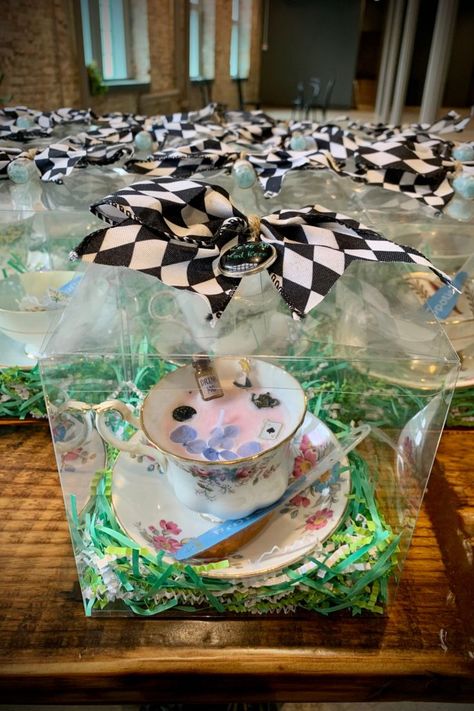 Bridal Party favors lined up on a table. Each bag contains a vintage tea cup and is sealed with a Alice in Wonderland-themed checkered bow. Outdoor Party Favors, Easter Tea Party, Candle Bridal Shower Favors, Alice In Wonderland Crafts, Surprise Birthday Decorations, Teacup Candle, Fairy Baby Showers, Bridal Shower Tea Party, Alice In Wonderland Gifts